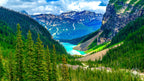 View from a glacier overlooking Lake Louise in Banff National Park, with a snow-capped mountain rising behind and the bright 