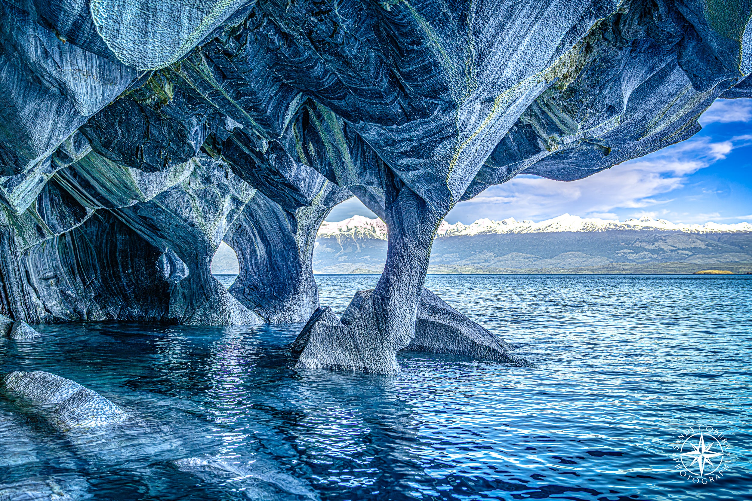 Thin marble column supporting a massive cave ceiling above General Carrera Lake in Chilean Patagonia.