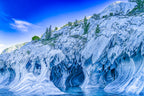 Marble cave formation resembling a fantastical house with door- and window-like shapes above a turquoise glacial lake in Chil