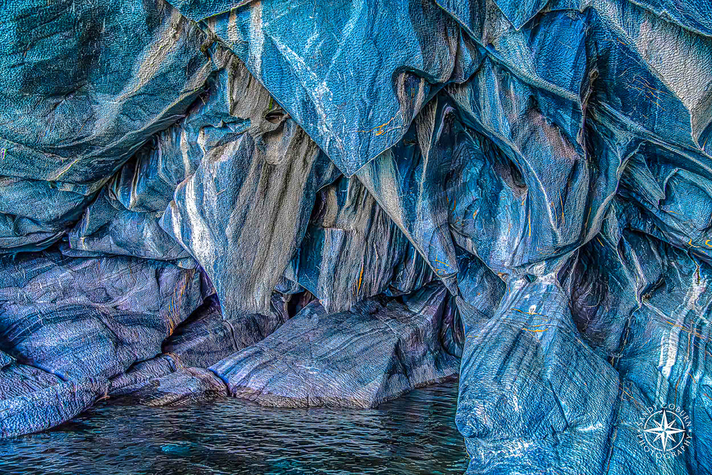 Close-up of striated blue marble with layered mineral textures resembling paint.