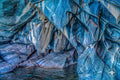 Close-up of striated blue marble with layered mineral textures resembling paint.
