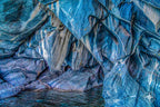 Close-up of striated blue marble with layered mineral textures resembling paint.
