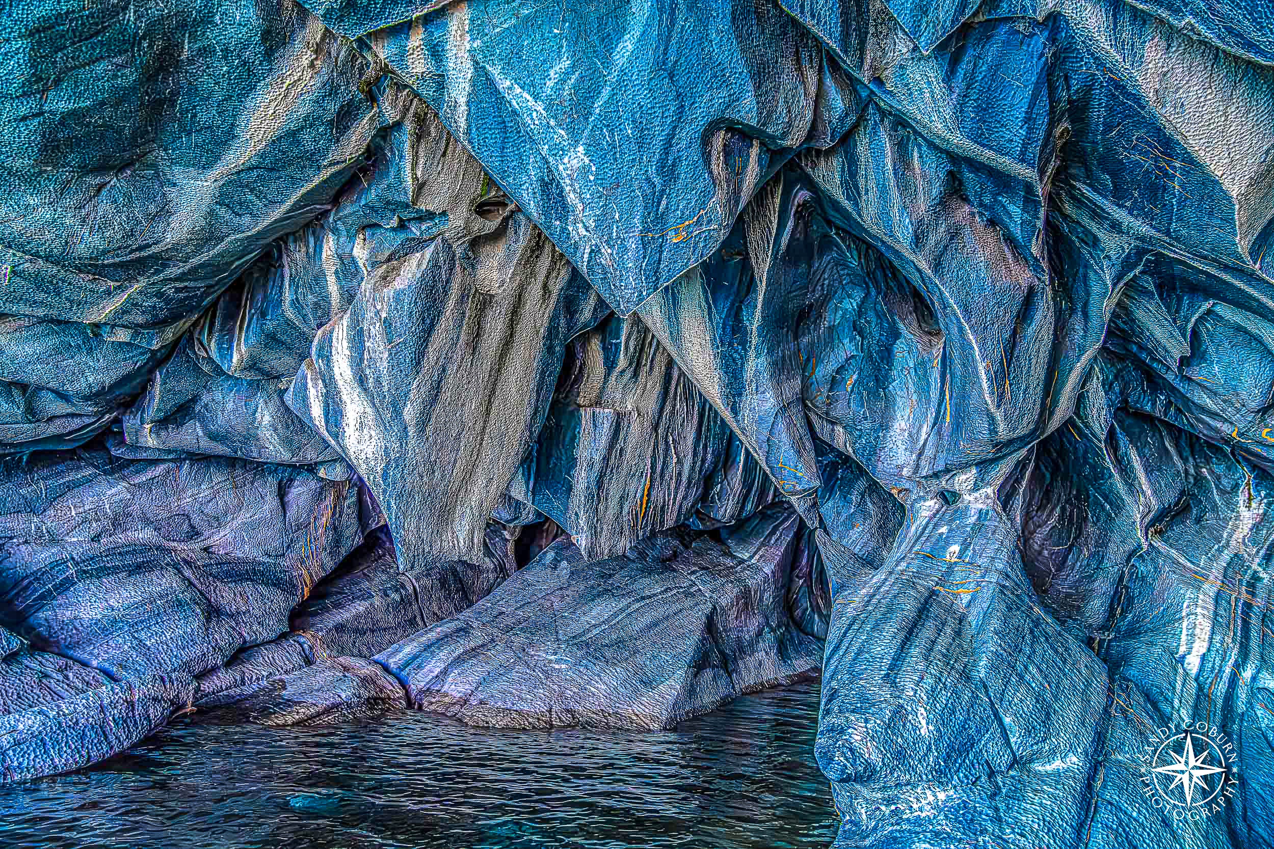 Close-up of striated blue marble with layered mineral textures resembling paint.