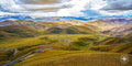 Snaking highway leading to Mount Everest’s base camp on the Tibetan Plateau, surrounded by rugged mountain terrain.