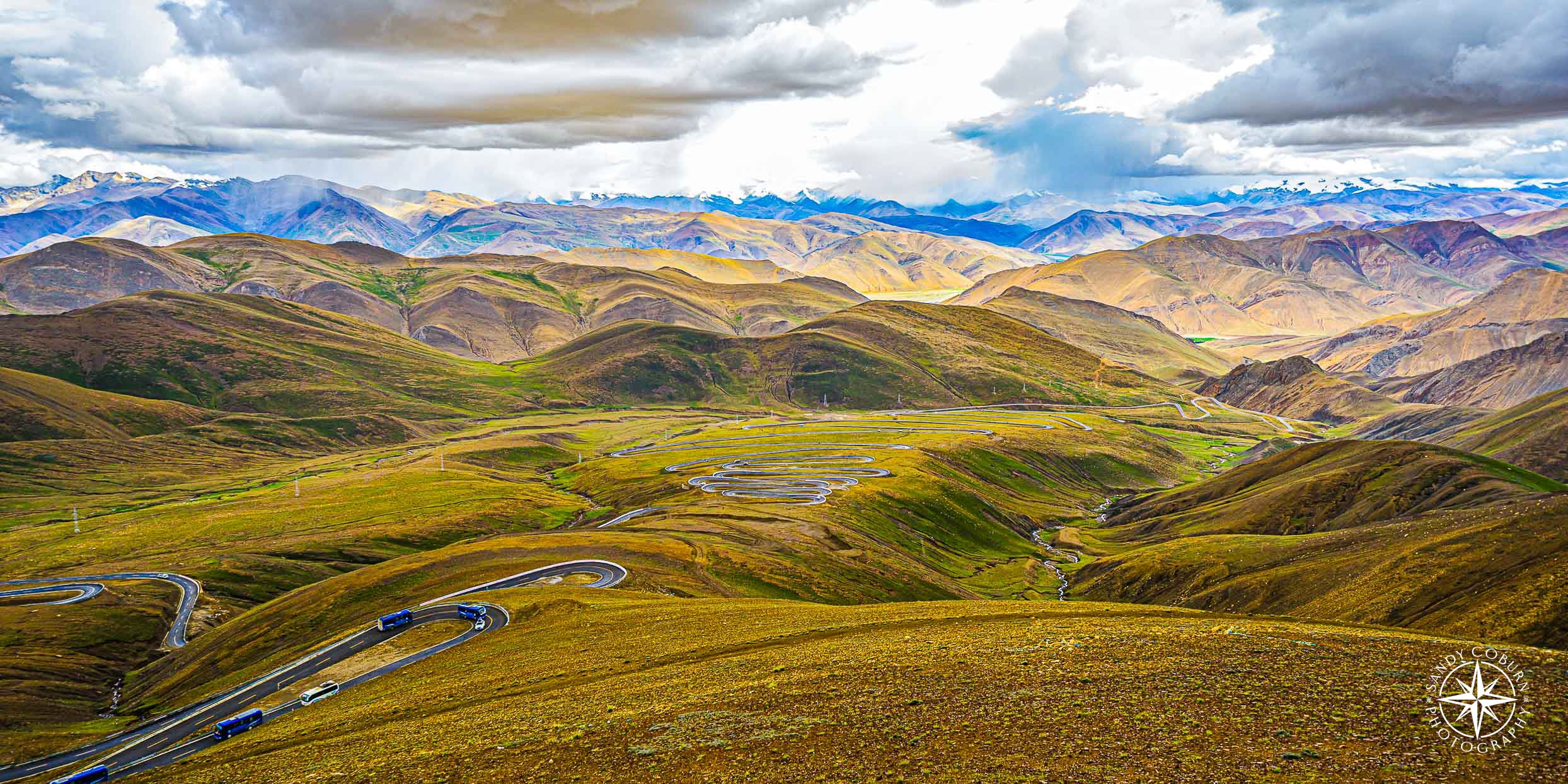 Snaking highway leading to Mount Everest’s base camp on the Tibetan Plateau, surrounded by rugged mountain terrain.